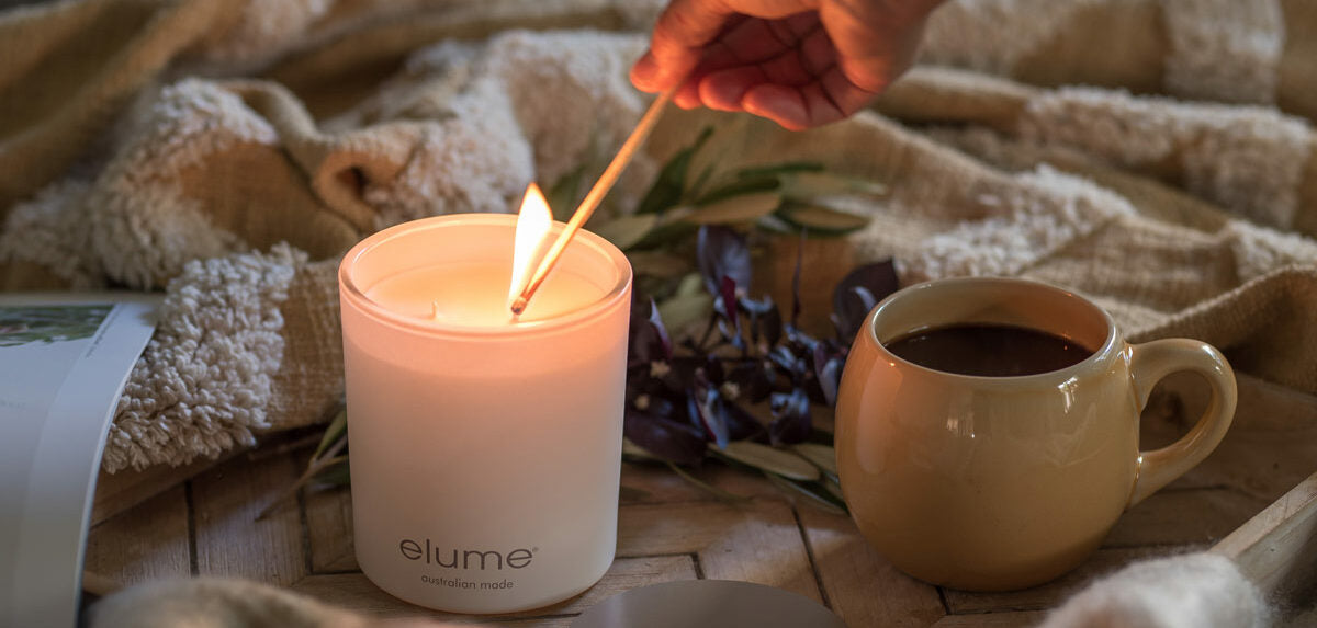 Elume pillar candle and diffuser on a pink background