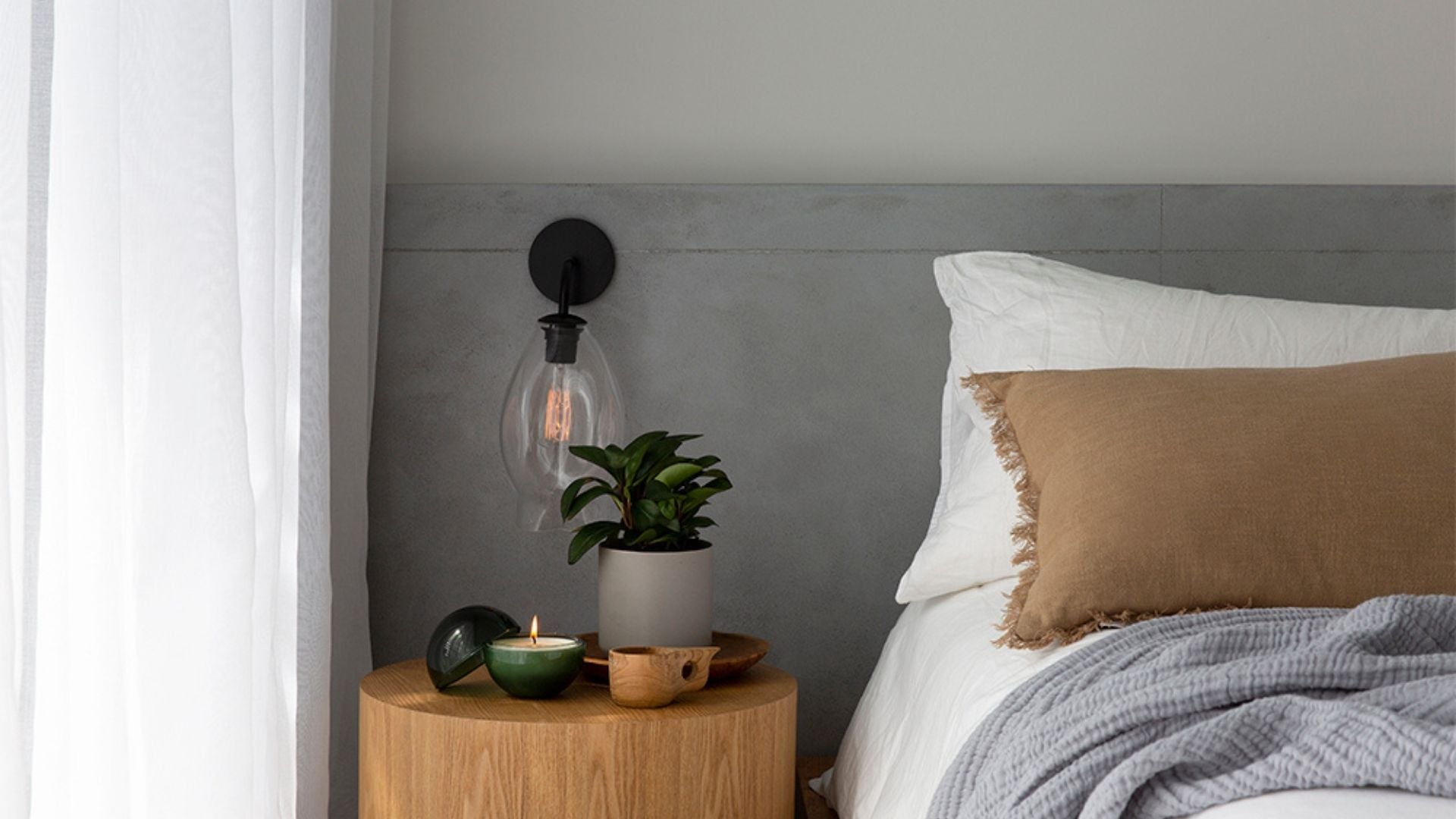 Only Orb candle in a grey and white bedroom