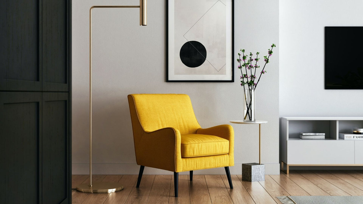 Living room scene with yellow armchair, floor lamp and print on the wall