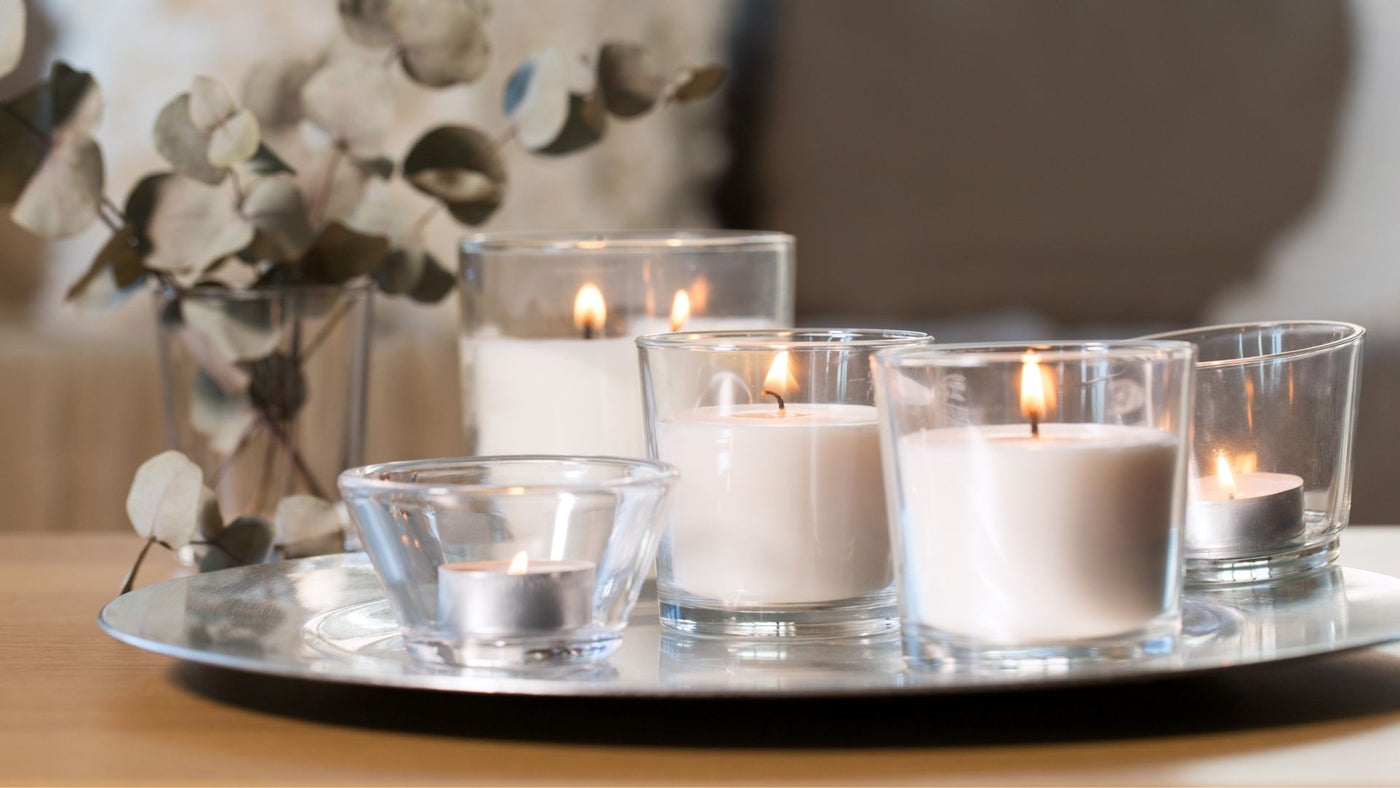 Lit decorative candles on a table in the home