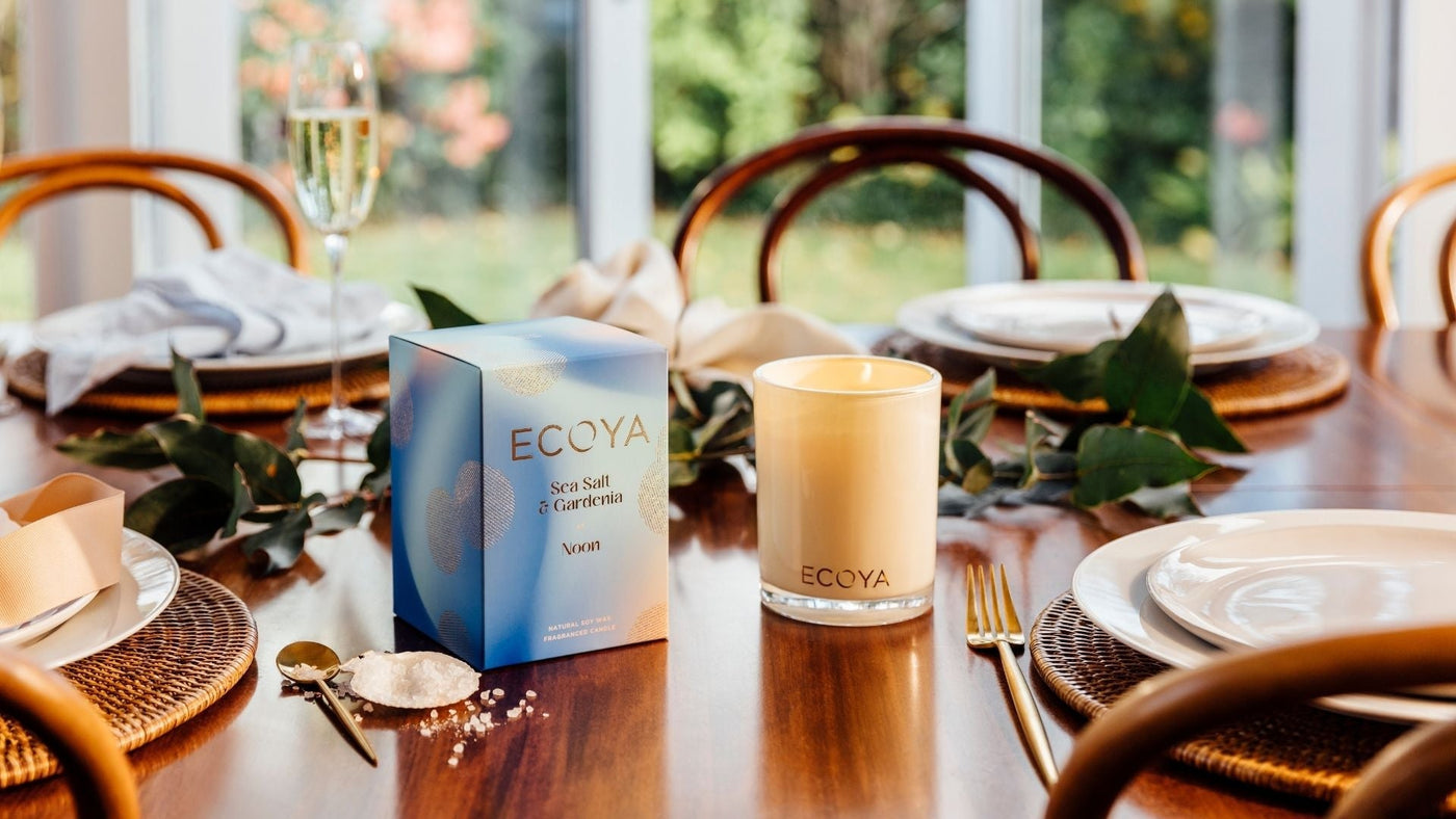 Ecoya festive dinner candles on the dining room table next to plates and cutlery