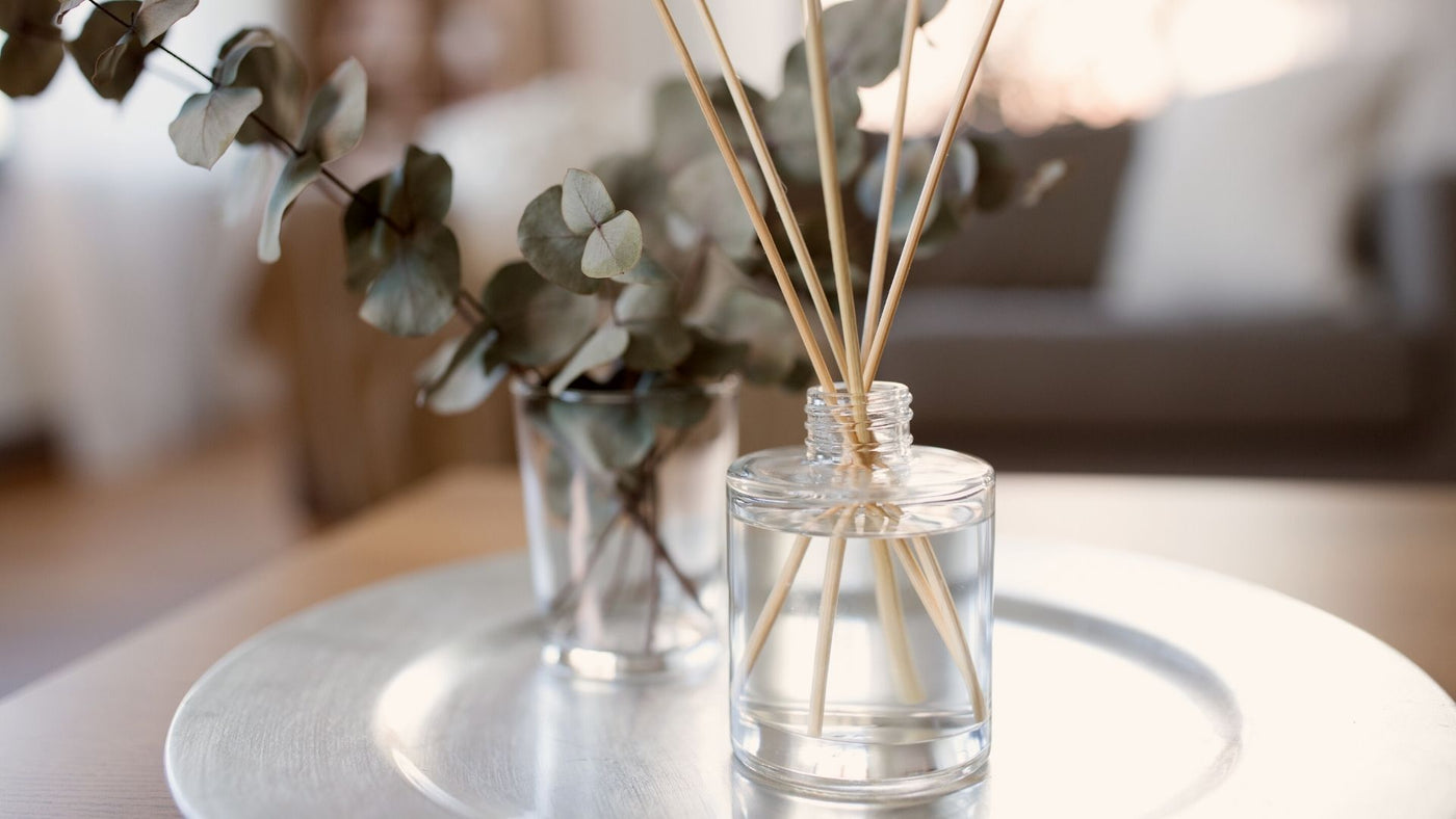 Glass essential oil diffuser on a plate in the home