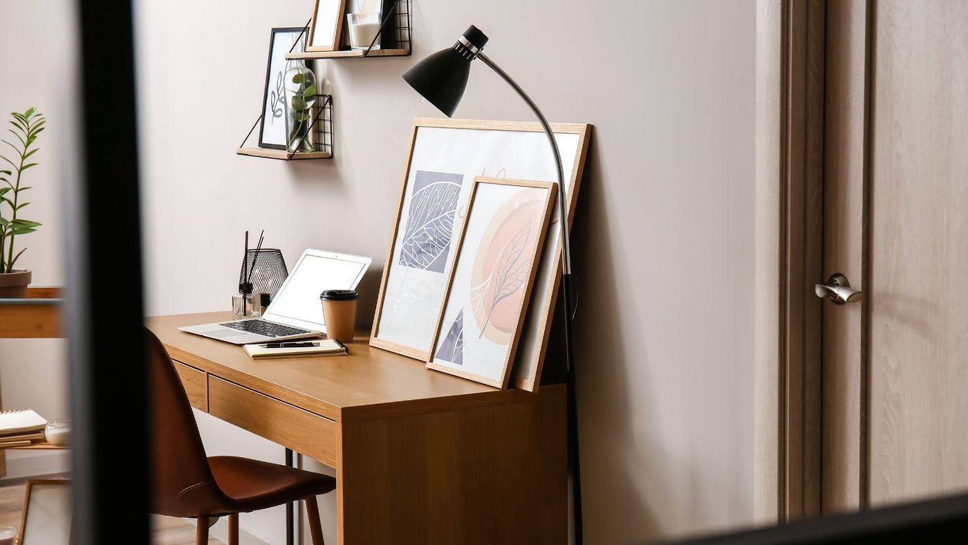 Glass scent diffuser sitting on a wooden desk in a home office